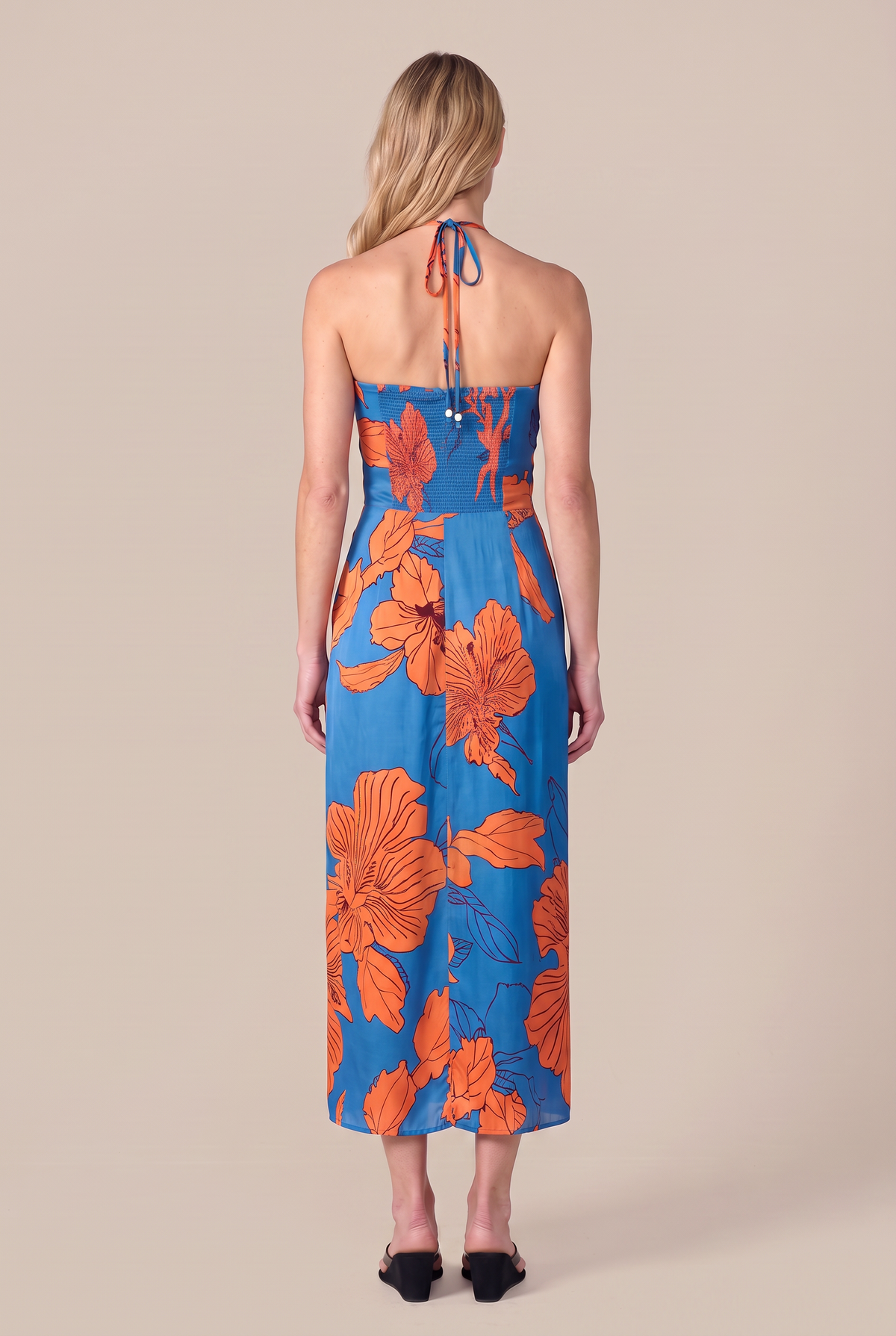 Poupette St Barth Long Dress Collina in Blue Hibiscus with flowing fabric and floral print, displayed on a hanger.