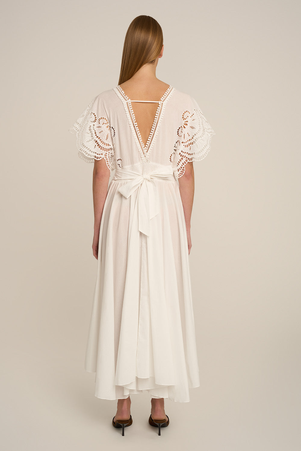 Natural white Poupette St Barth Kaftan Hina with flowing fabric, back view showcasing relaxed, elegant style.