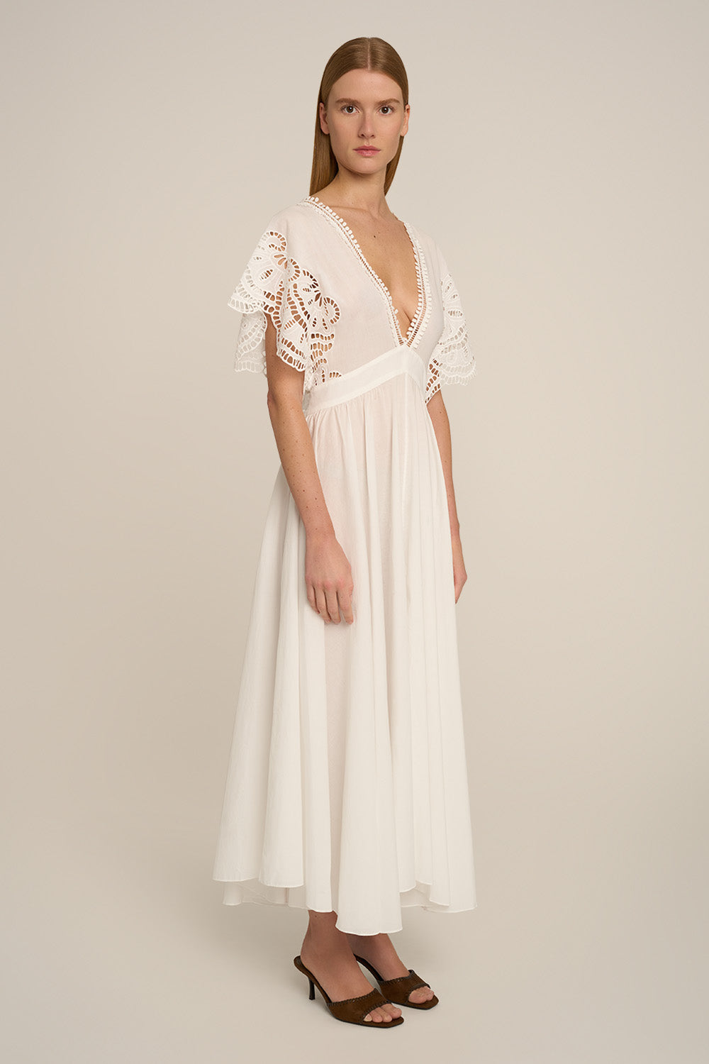 Natural white Poupette St Barth Kaftan Hina with flowing fabric and elegant design, shown from side view.
