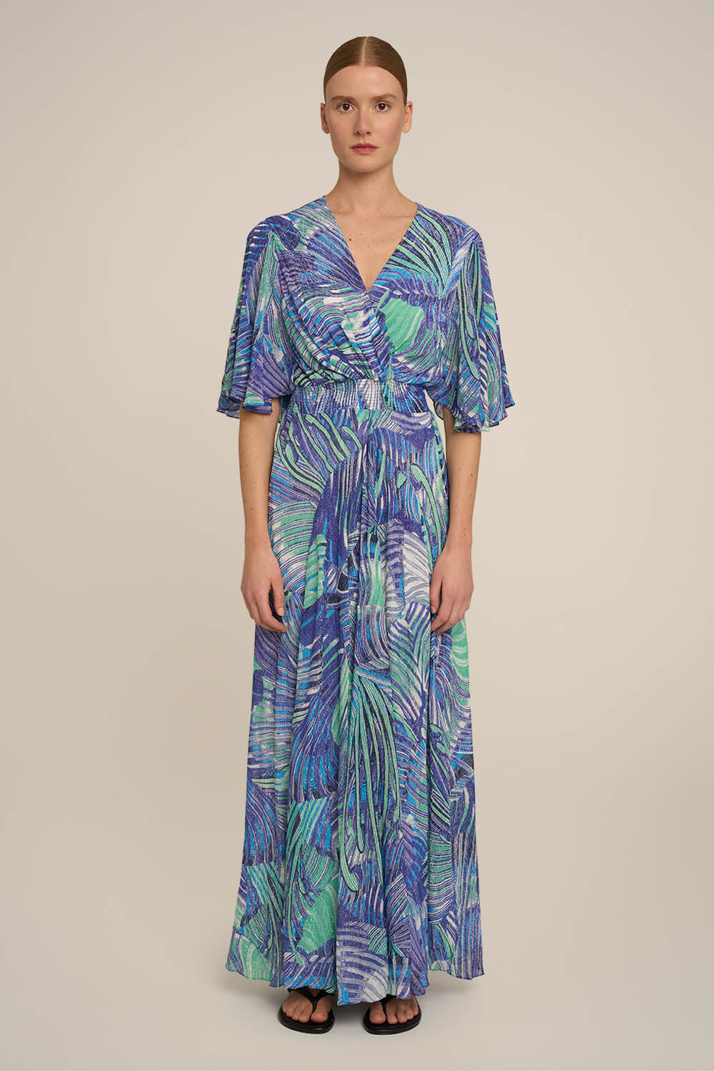 Blue long dress by Poupette St Barth, featuring a flowing design and elegant style, worn by a model.