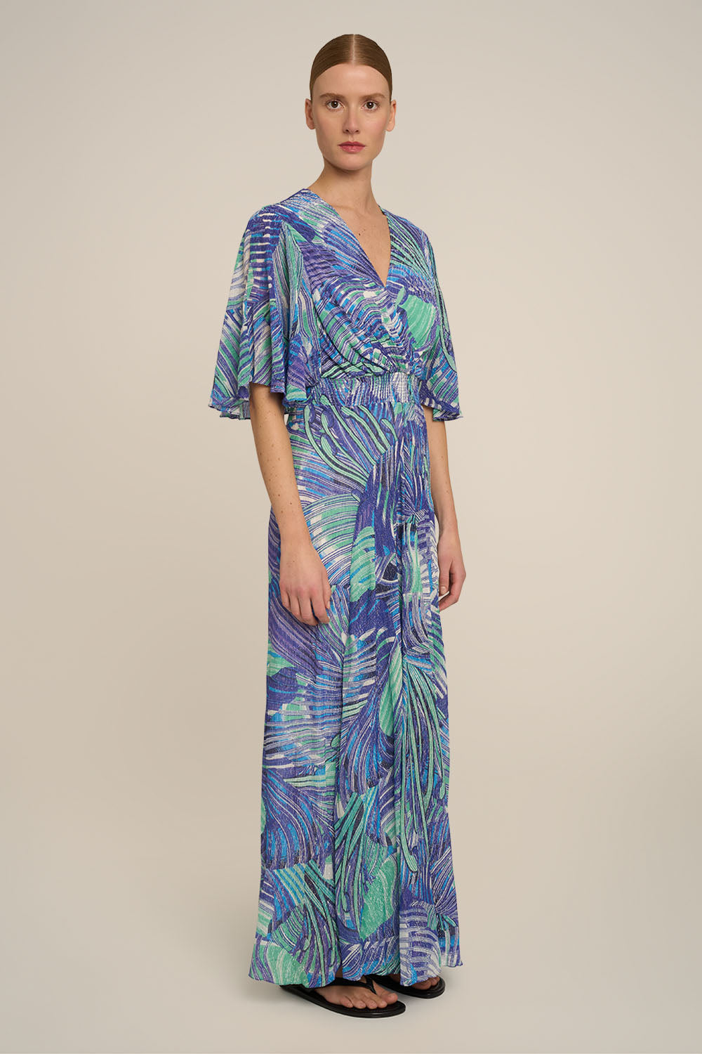 Blue long dress Grace by Poupette St Barth, featuring flowing fabric and elegant design, shown from the side view.