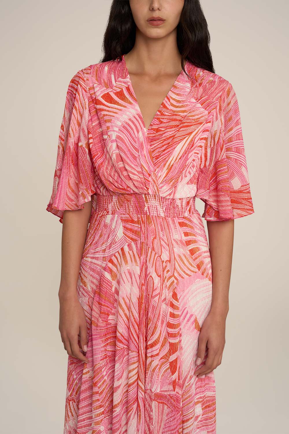 Pink long dress named Grace by Poupette St Barth, featuring flowing fabric and elegant design, shown on a model.
