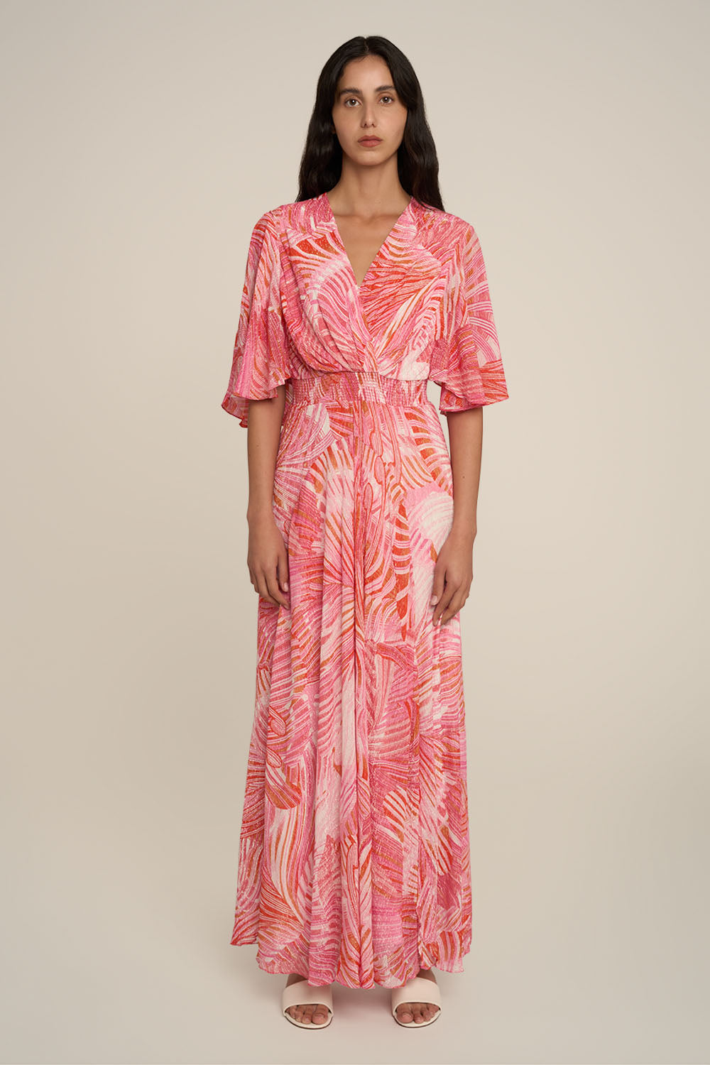 Pink long dress by Poupette St Barth, featuring a flowing design and elegant silhouette, shown from the front.