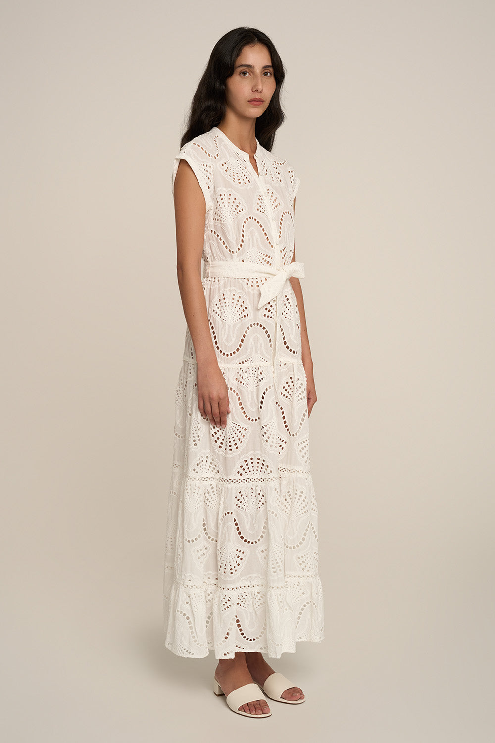 Long white Kora long dress by Poupette St Barth, flowing fabric and side view detail.