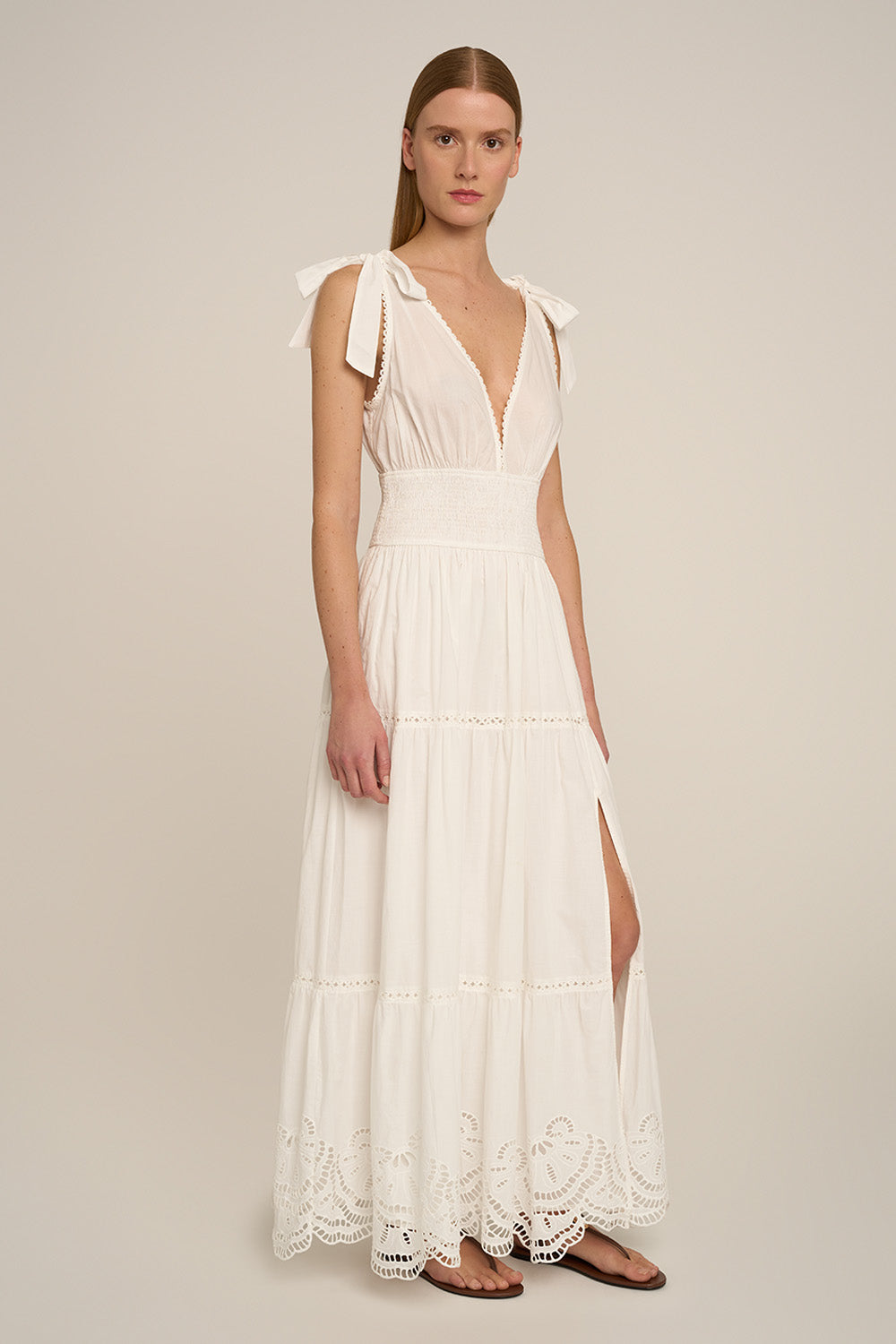 Long Luiza dress by Poupette St Barth in natural white, featuring a flowing silhouette and elegant design, shown from side view.