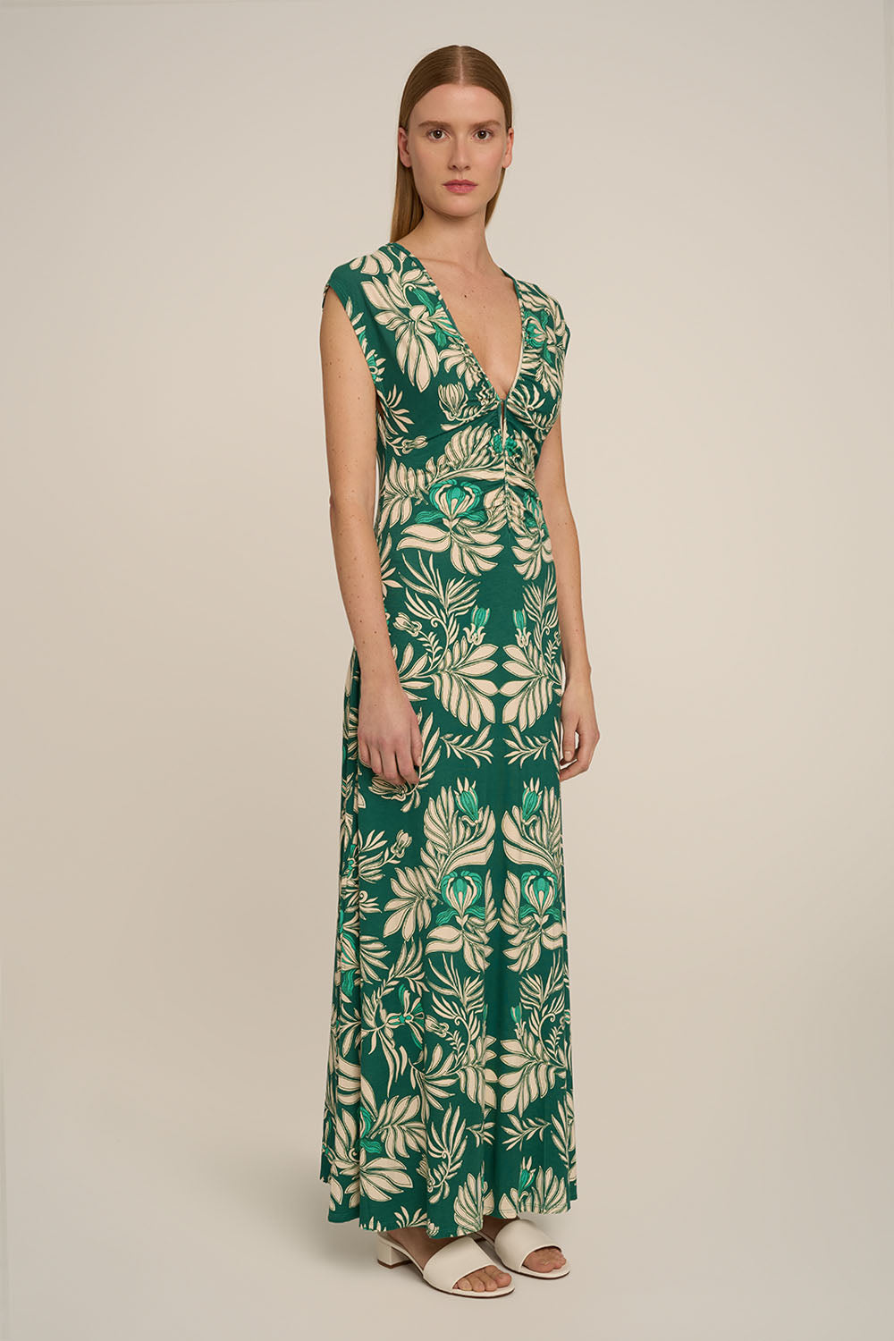 Green long dress Nova by Poupette St Barth, featuring flowing fabric and elegant design, shown from the side view.