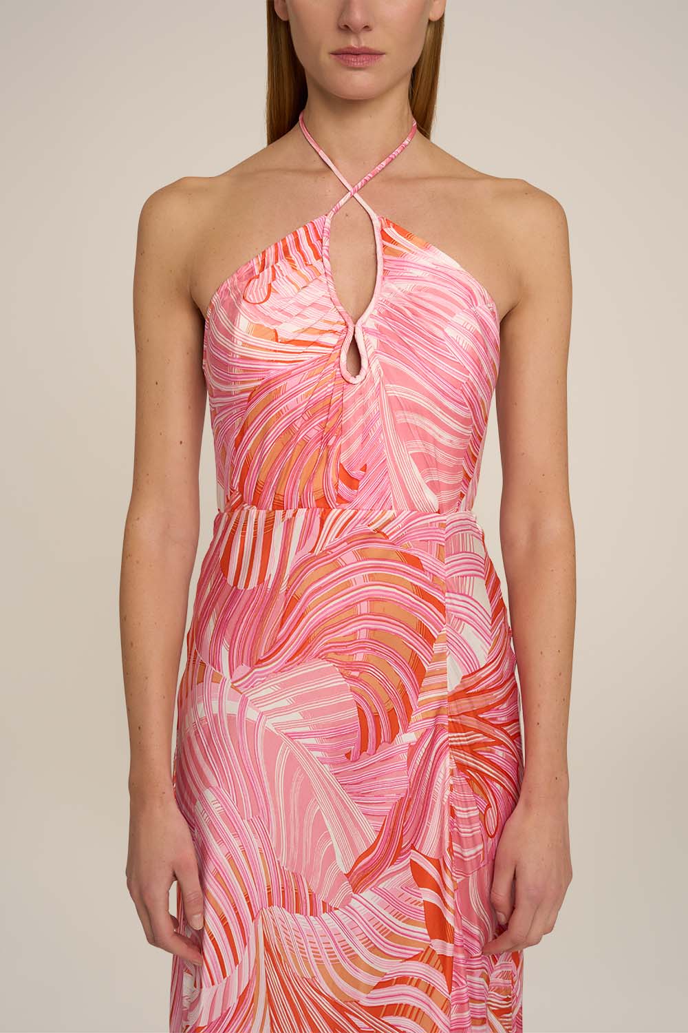 Pink Stella long dress by Poupette St Barth featuring a flowing silhouette and elegant design, displayed on a hanger.