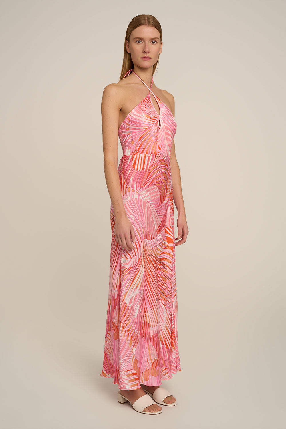 Pink Stella long dress by Poupette St Barth, featuring flowy fabric and elegant design, shown from a side view.