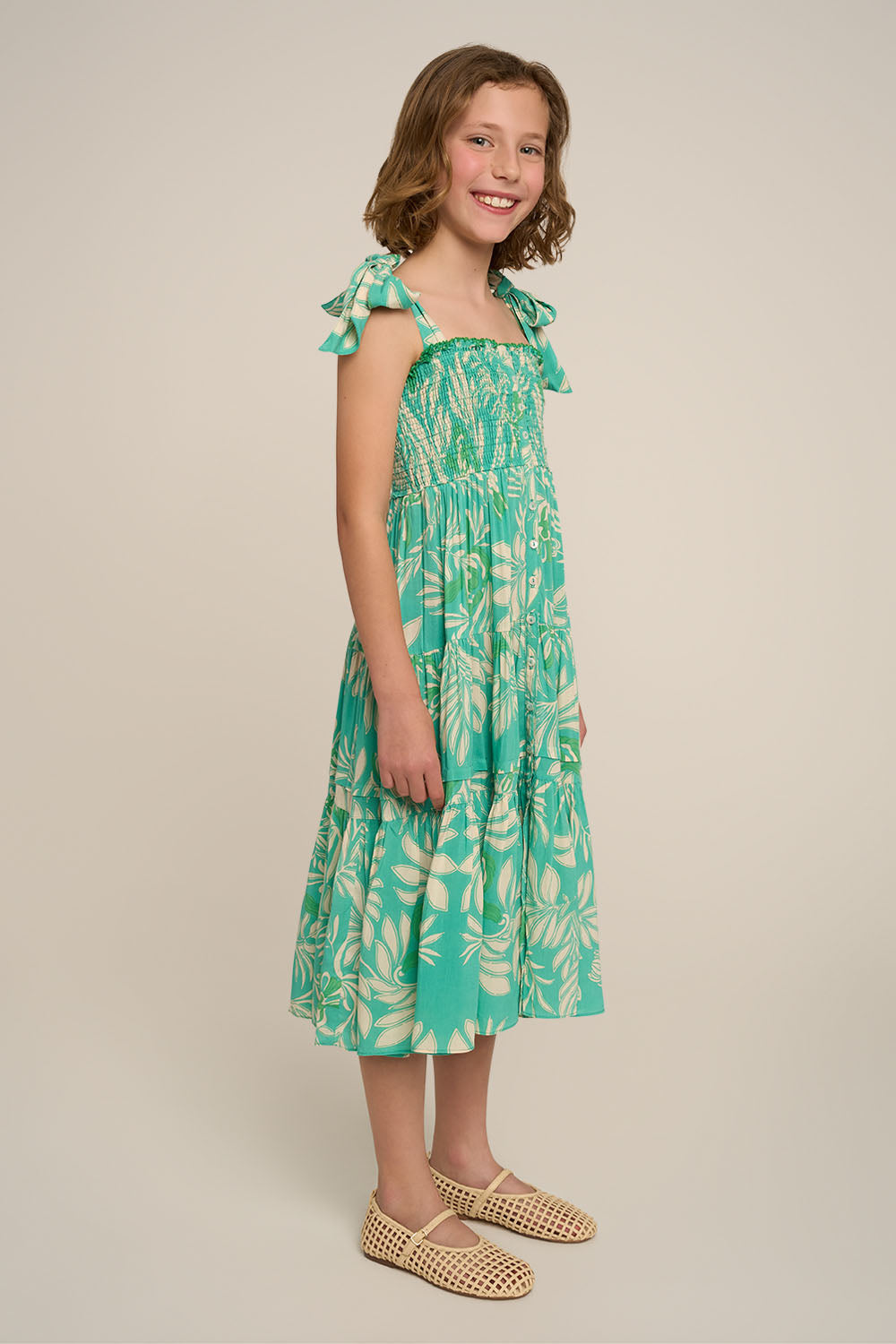 Girl wearing a long aqua Kerylos dress from Poupette St Barth, stylish and flowy for special occasions.