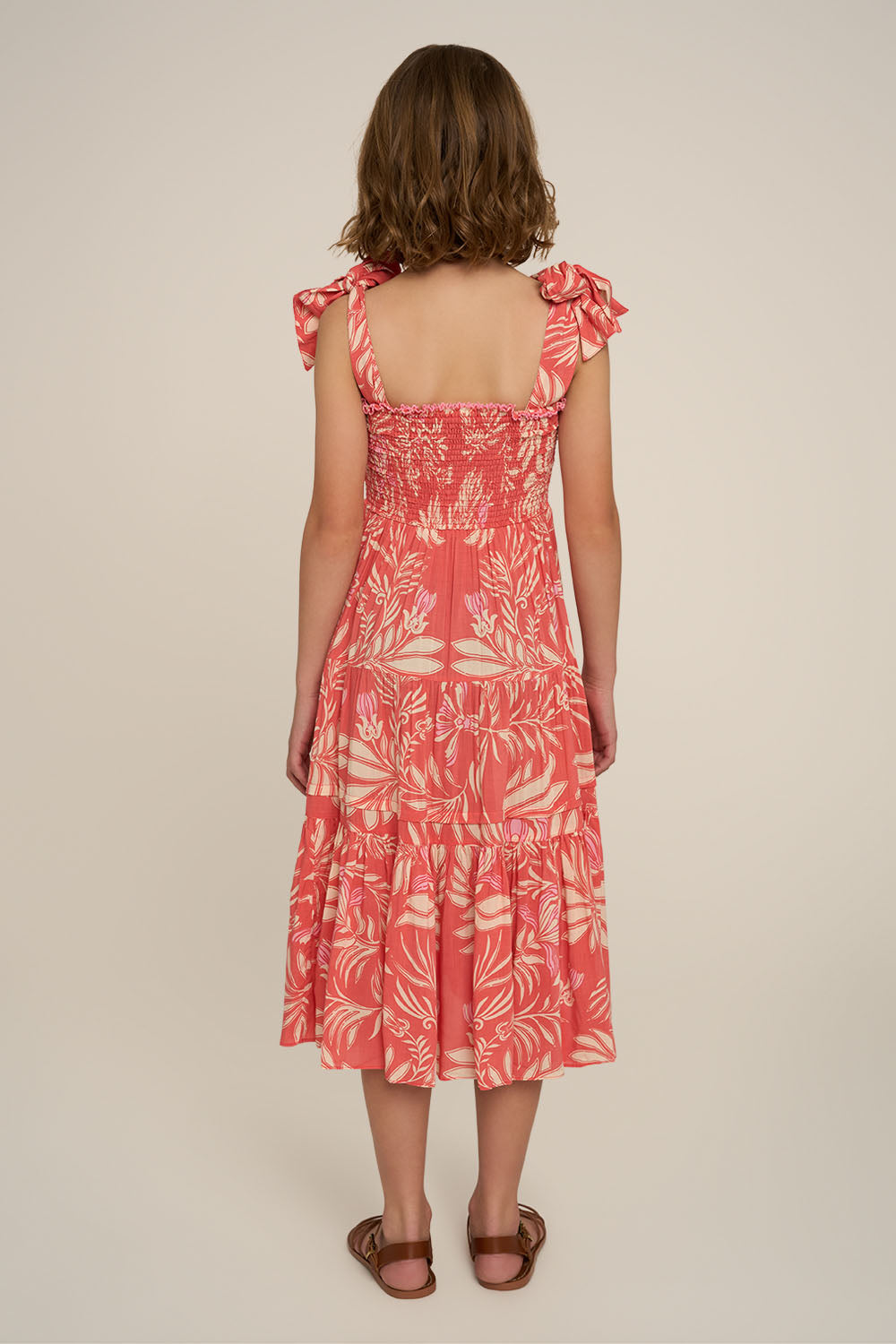 Pink long girl’s dress from Poupette St Barth’s Triny collection, shown from the back with flowing fabric and elegant style.