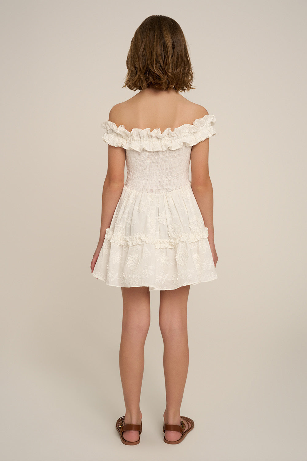 Girls' mini dress Amber by Poupette St Barth in natural white, plain design, shown from the back.