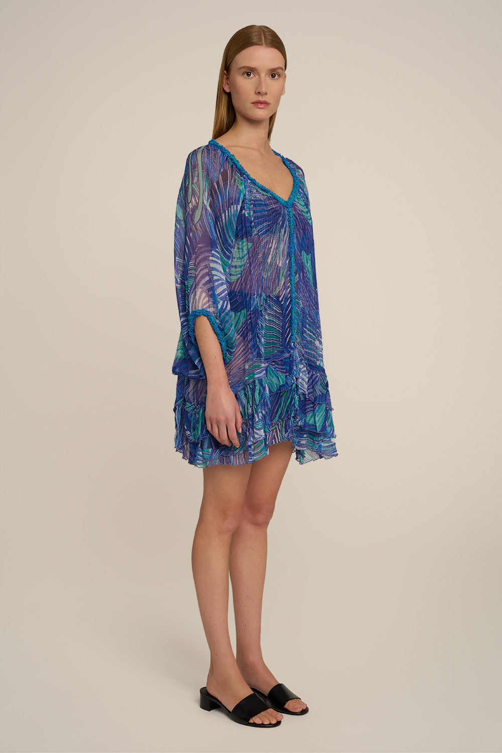 Blue Nava Poncho by Poupette St Barth featuring a relaxed fit and lightweight fabric, shown from the side.