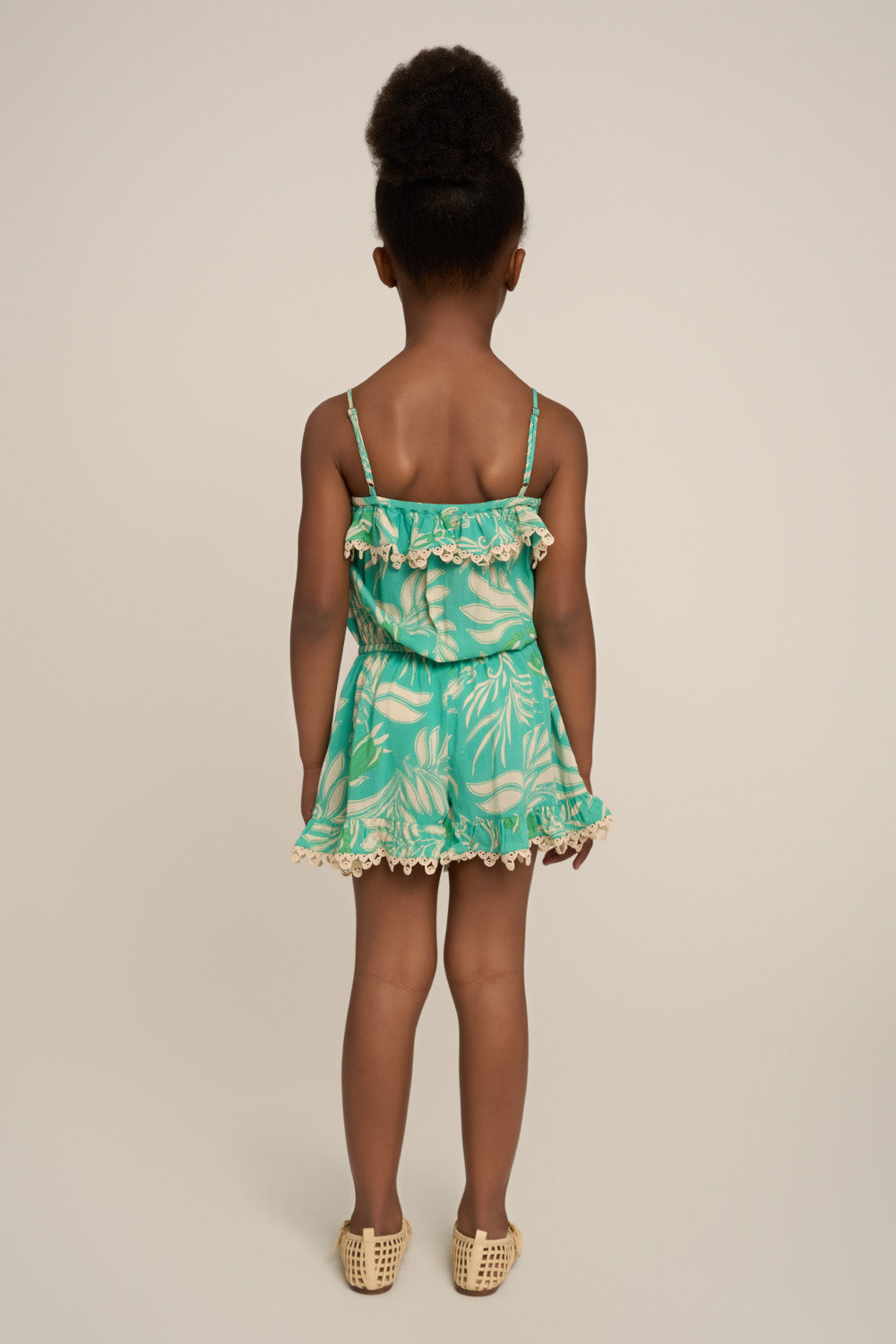 Back view of Poupette St Barth girl's aqua short jumpsuit Angel with short sleeves and a relaxed fit.