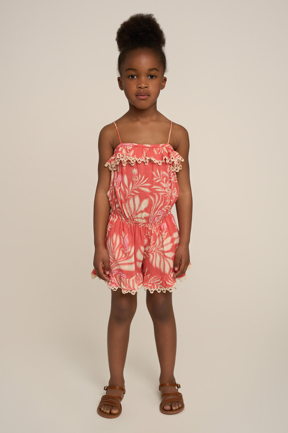 Pink short jumpsuit for girls featuring angel design by Poupette St Barth, shown from the front.