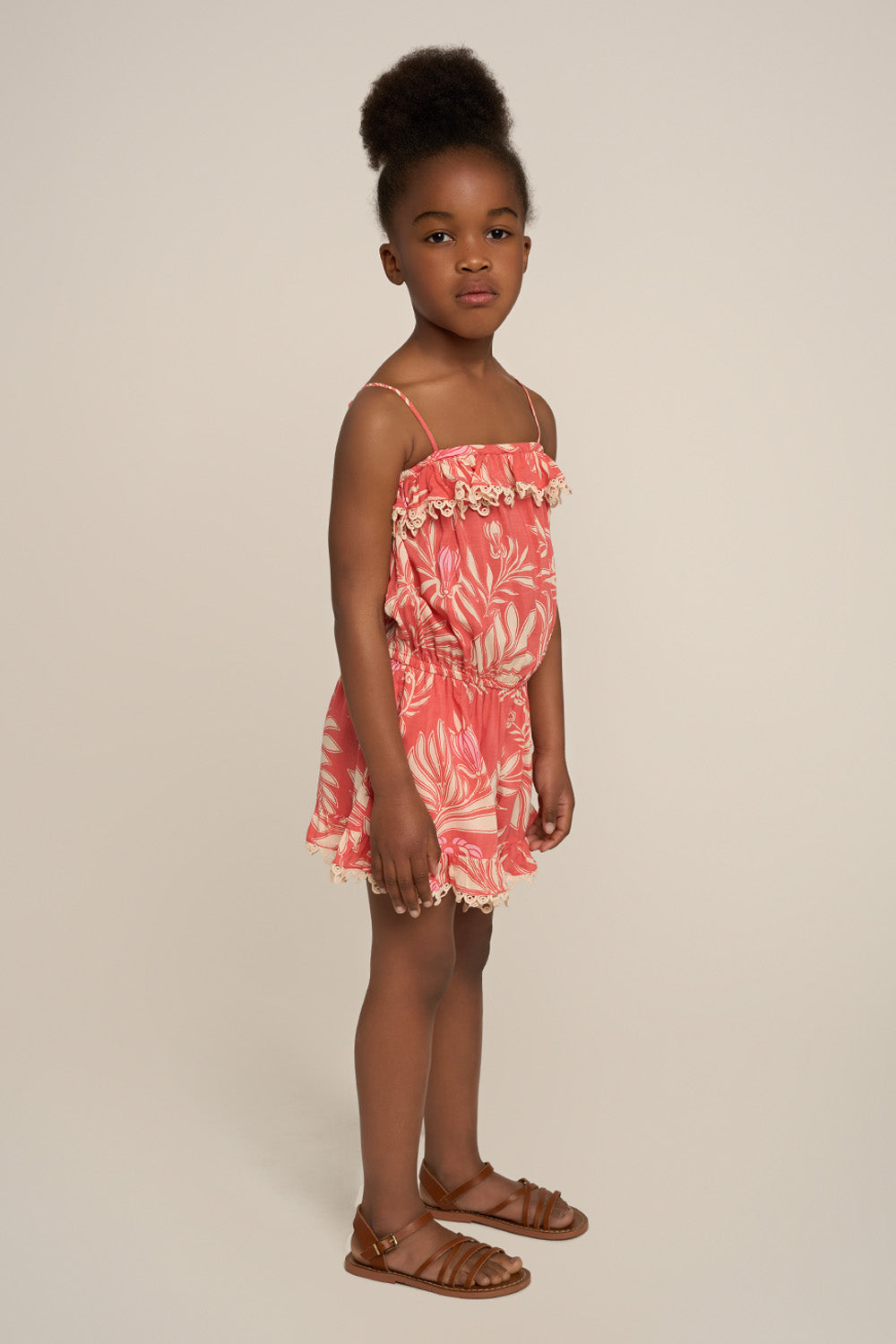 Pink girl’s short jumpsuit Angel by Poupette St Barth, featuring a stylish design and comfortable fit, seen from the side.