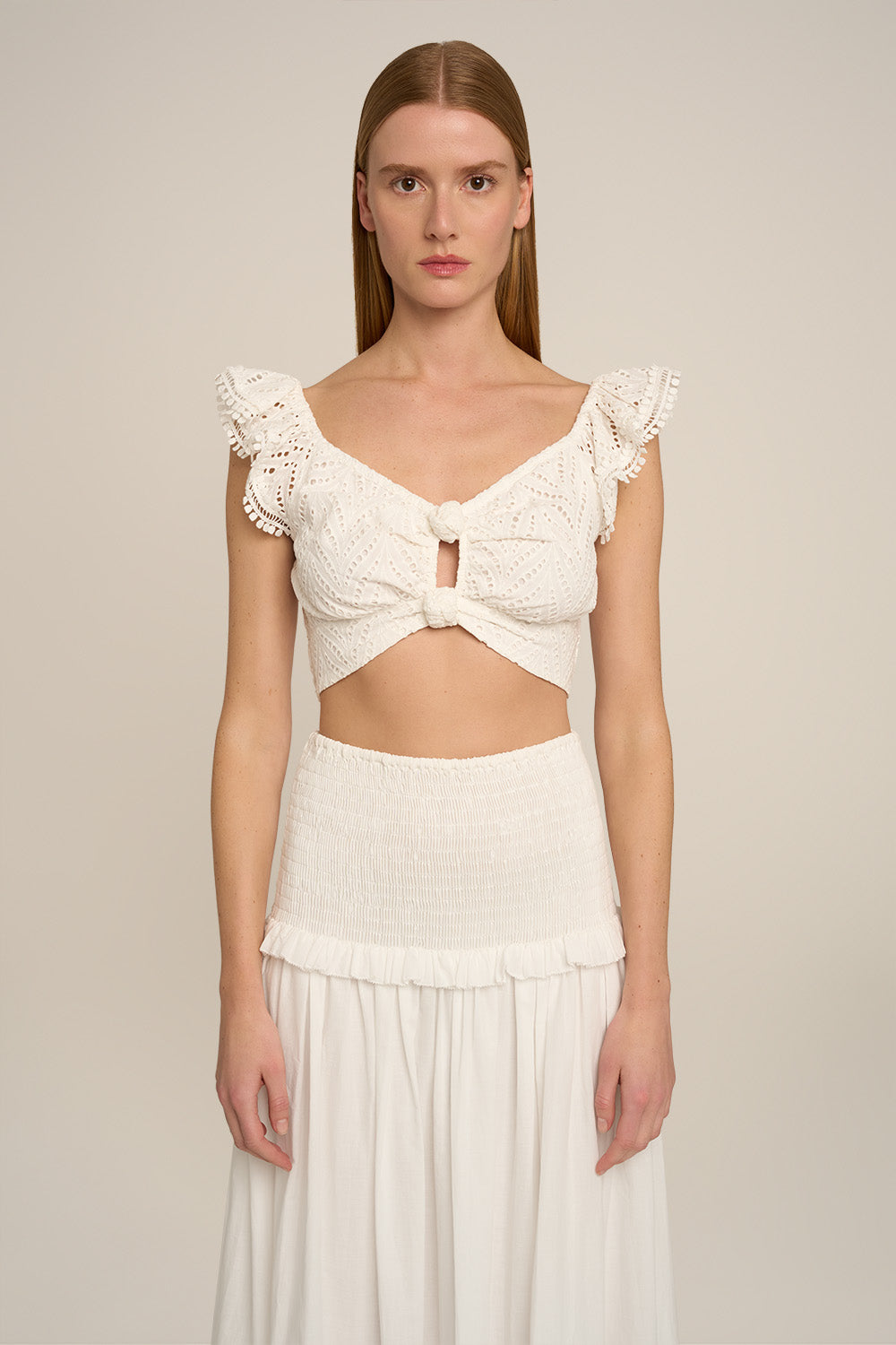 Poupette St Barth Top Bella in natural white, plain, sleeveless design, shown with a long skirt, front view.
