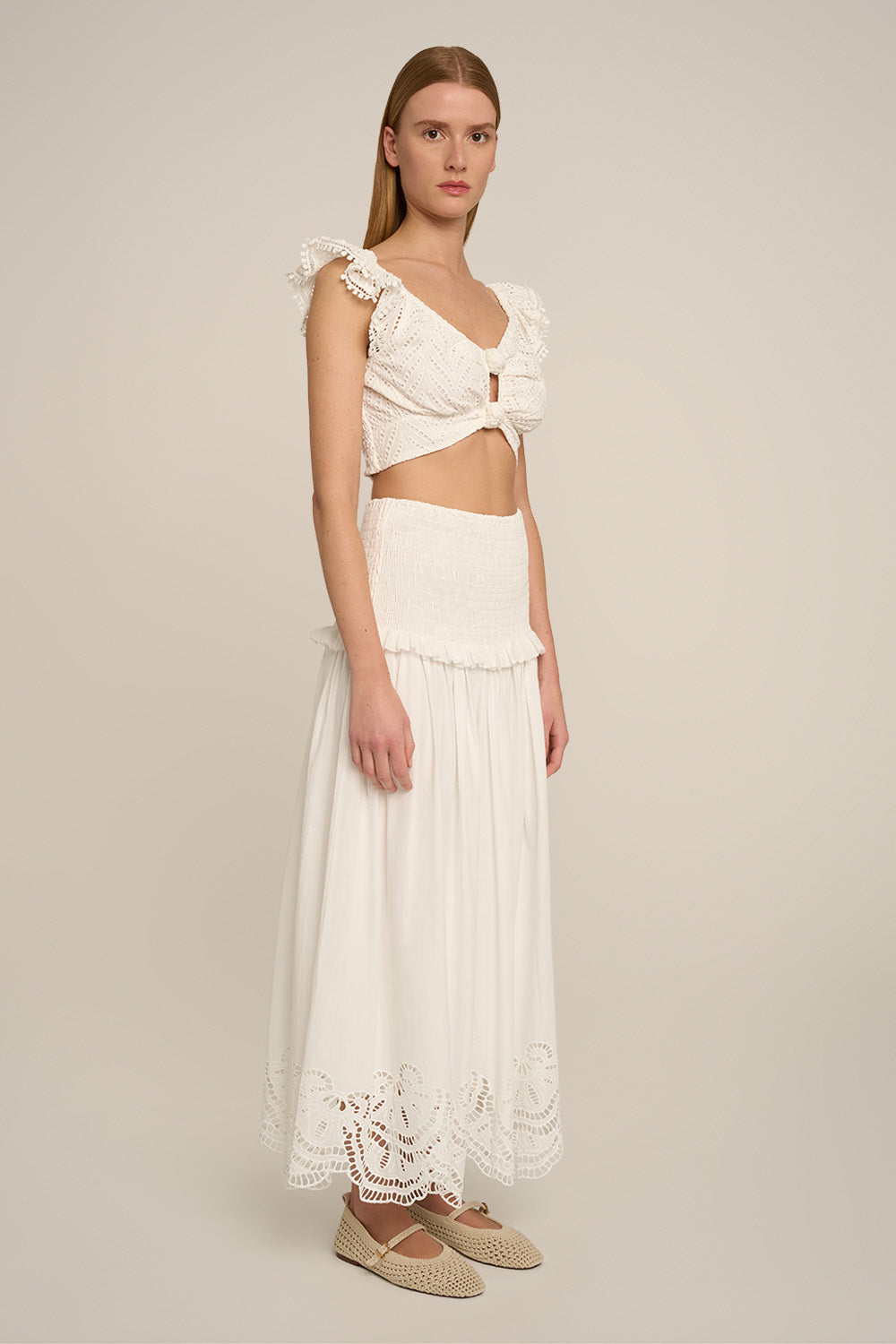 Long Fiona skirt in natural white by Poupette St Barth, shown from the side with a flowing, elegant design and lightweight fabric.