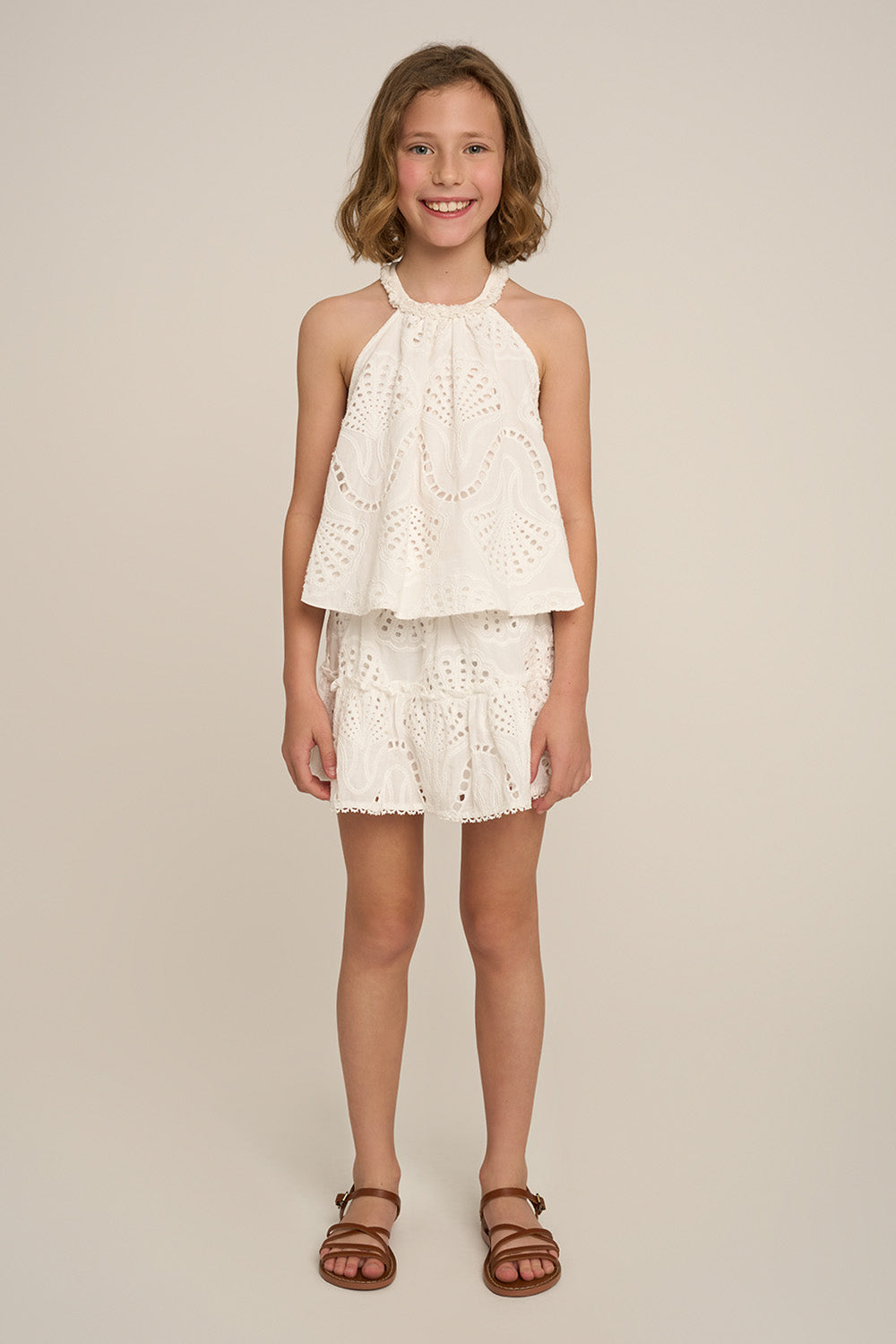 Girls' mini skirt by Poupette St Barth in natural white, plain design, front view showing soft fabric and simple style.