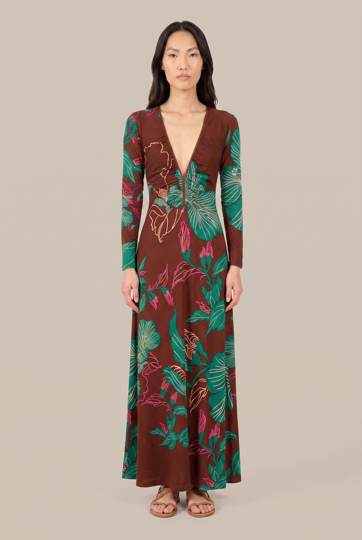Long Bossa dress by Poupette St Barth in brown hibiscus print, featuring a flowing silhouette and tropical floral design.