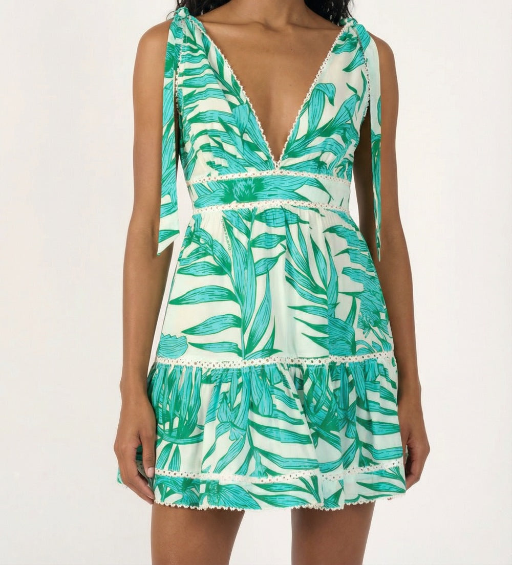 Green cotton mini dress with palm leaf print from Poupette St Barth's Cara collection, featuring a stylish, lightweight design.