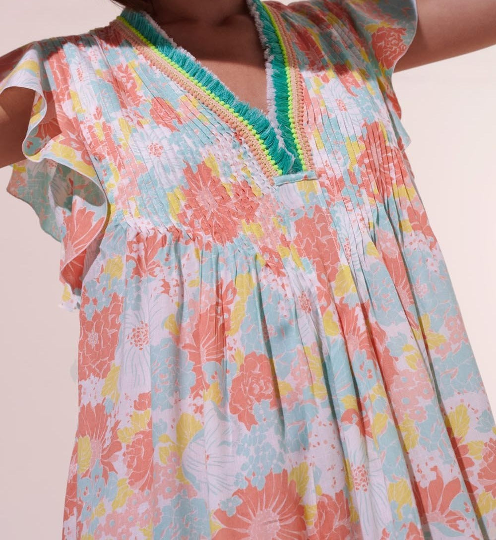 Poupette St Barth Mini Dress Sasha in orange flower print, lightweight viscose fabric, short sleeveless design with vibrant floral pattern.