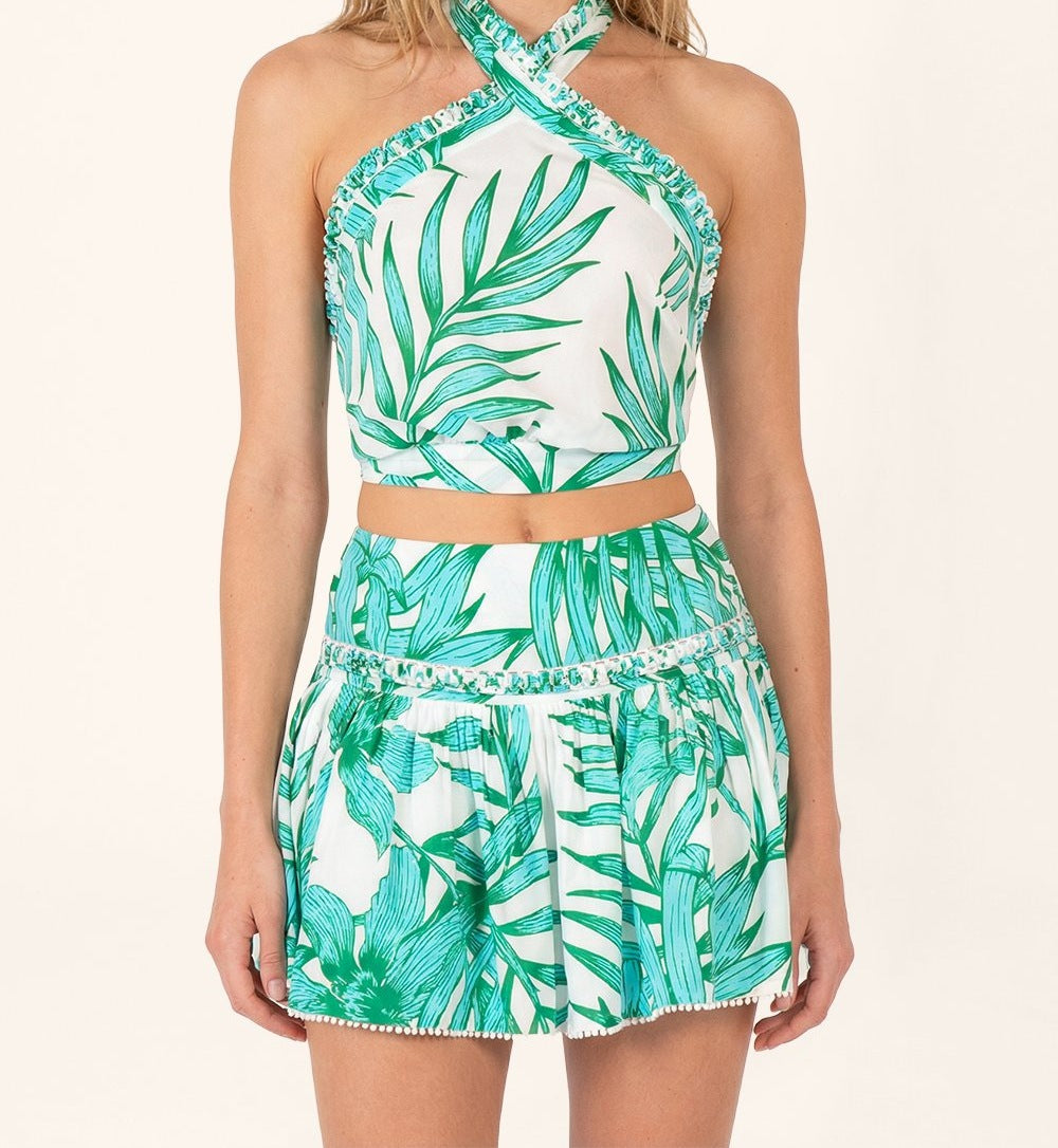 Green cotton mini skirt with palm leaf pattern by Poupette St Barth, featuring a fitted waist and stylish summer design.