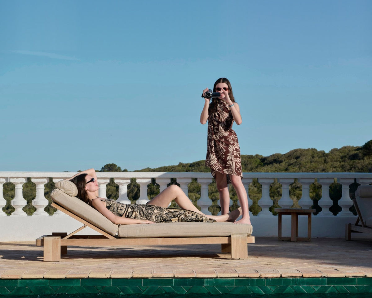 Woman lounging poolside and girl filming her, wearing Poupette St Barth prints