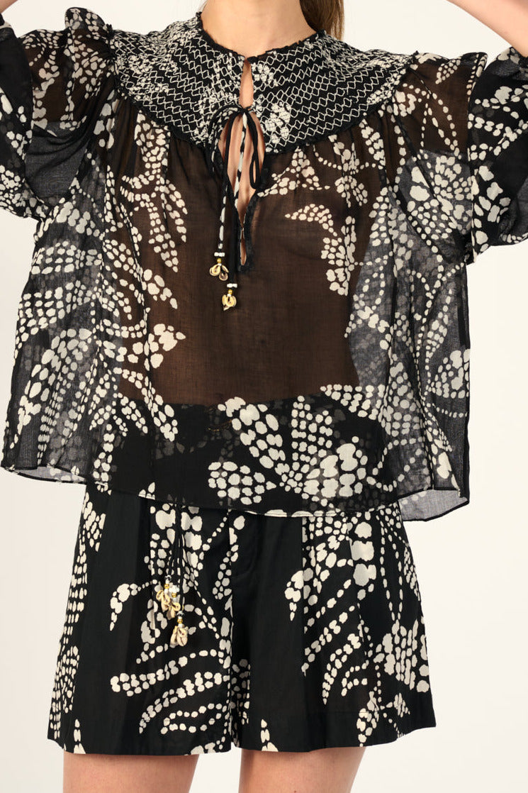 Black Austral cotton blouse by Poupette St Barth, featuring a relaxed fit and sari gauze fabric, styled on a model.