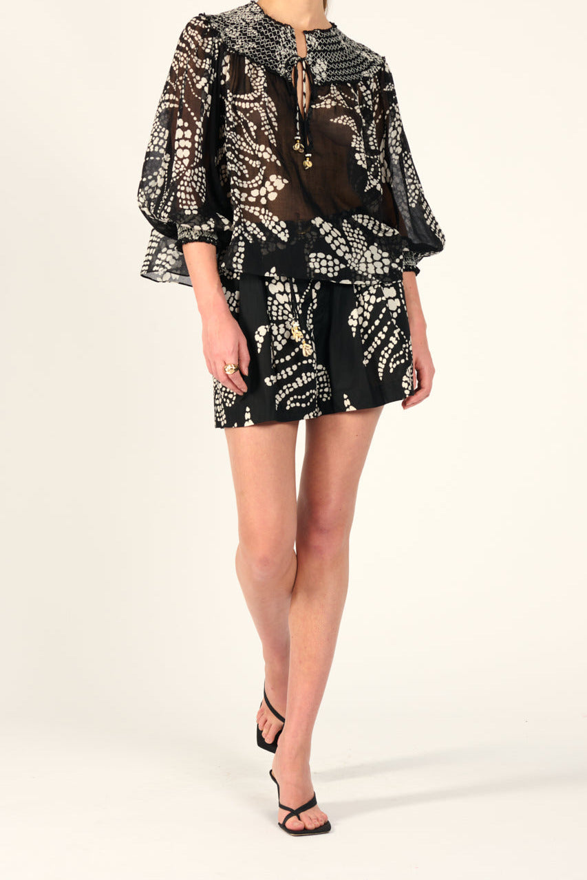Black Austral cotton blouse by Poupette St Barth featuring a loose fit, gauze fabric, and elegant drape.