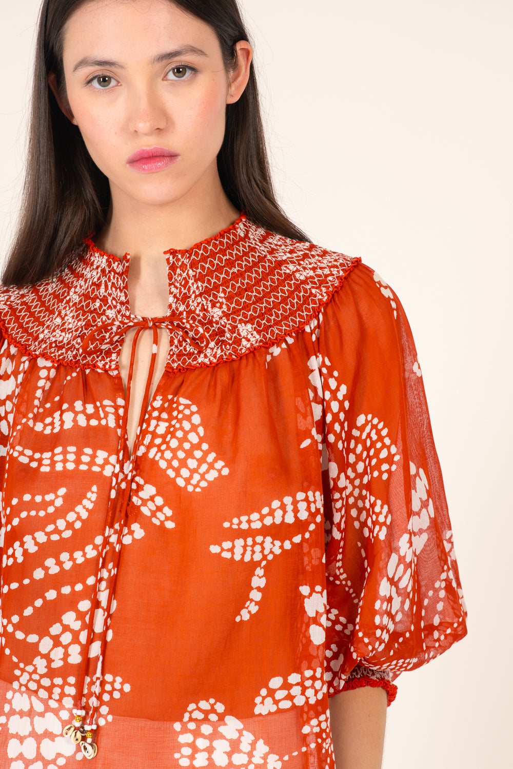 Poupette St Barth Ysee blouse in paprika color, short style with a flowy fabric, displayed on a mannequin.
