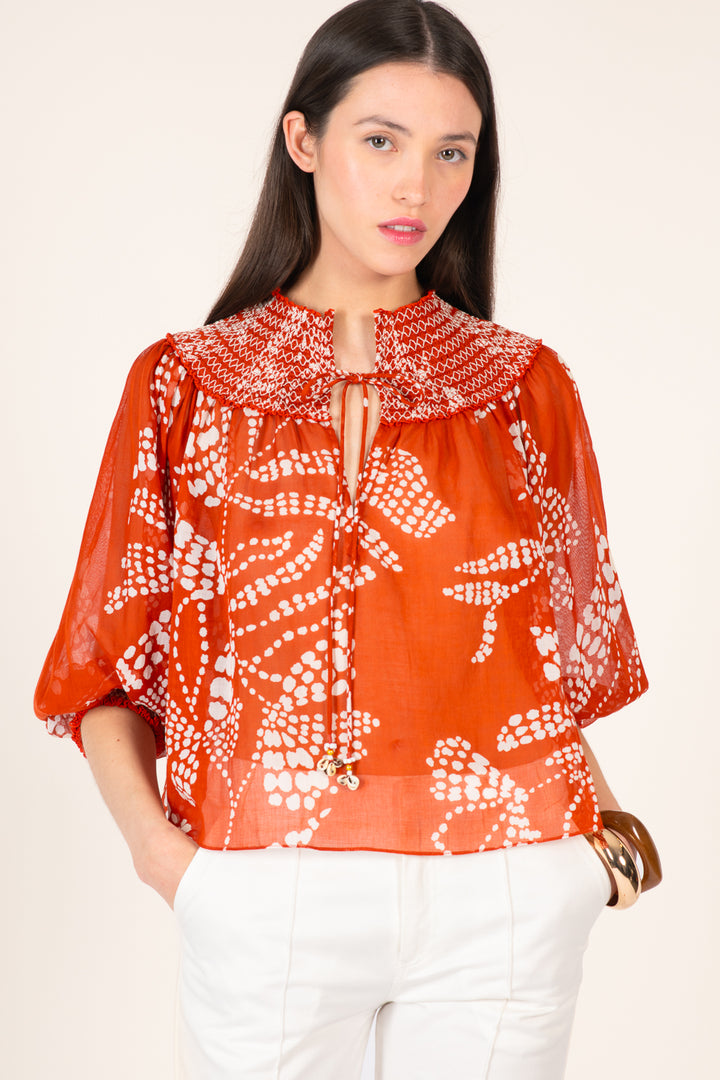 Light orange Ysee blouse by Poupette St Barth featuring a relaxed fit and short sleeves, styled on a hanger against a neutral background.