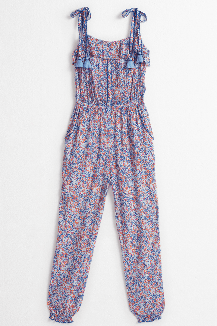 Kids long jumpsuit Astra by Poupette St Barth in light blue with paquerette floral print, front view showing its relaxed fit.