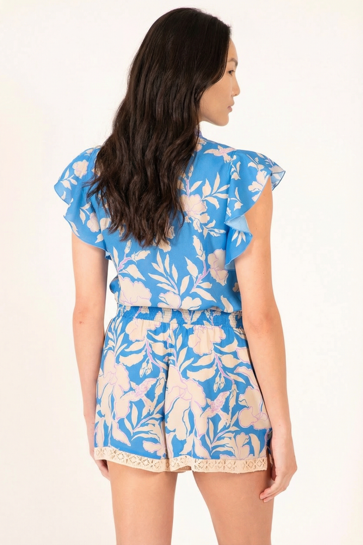 Blue palm print short jumpsuit by Poupette St Barth, featuring a relaxed fit and stylish straps.