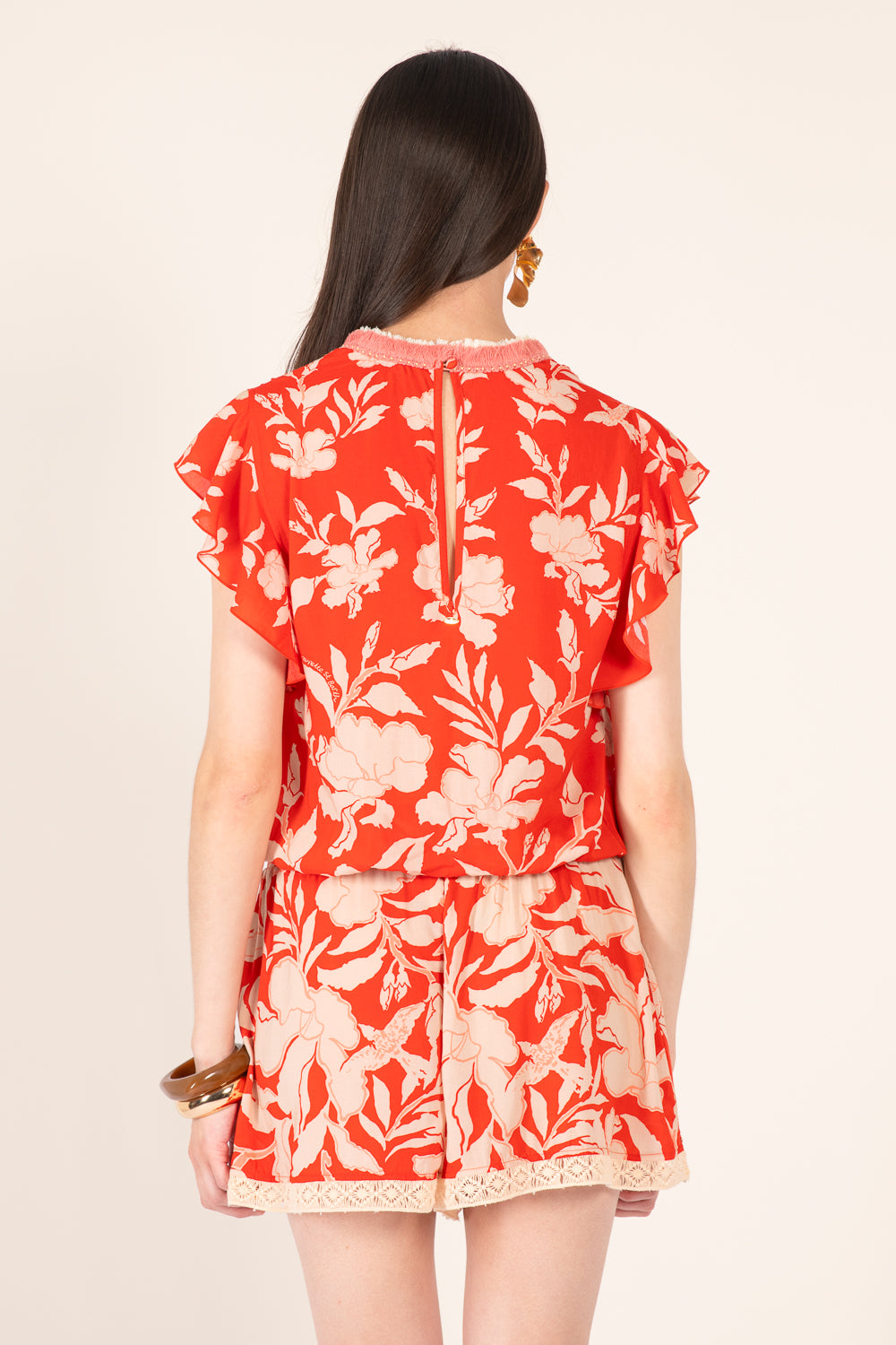 Coral palm print short jumpsuit by Poupette St Barth featuring a relaxed fit and sleeveless design.