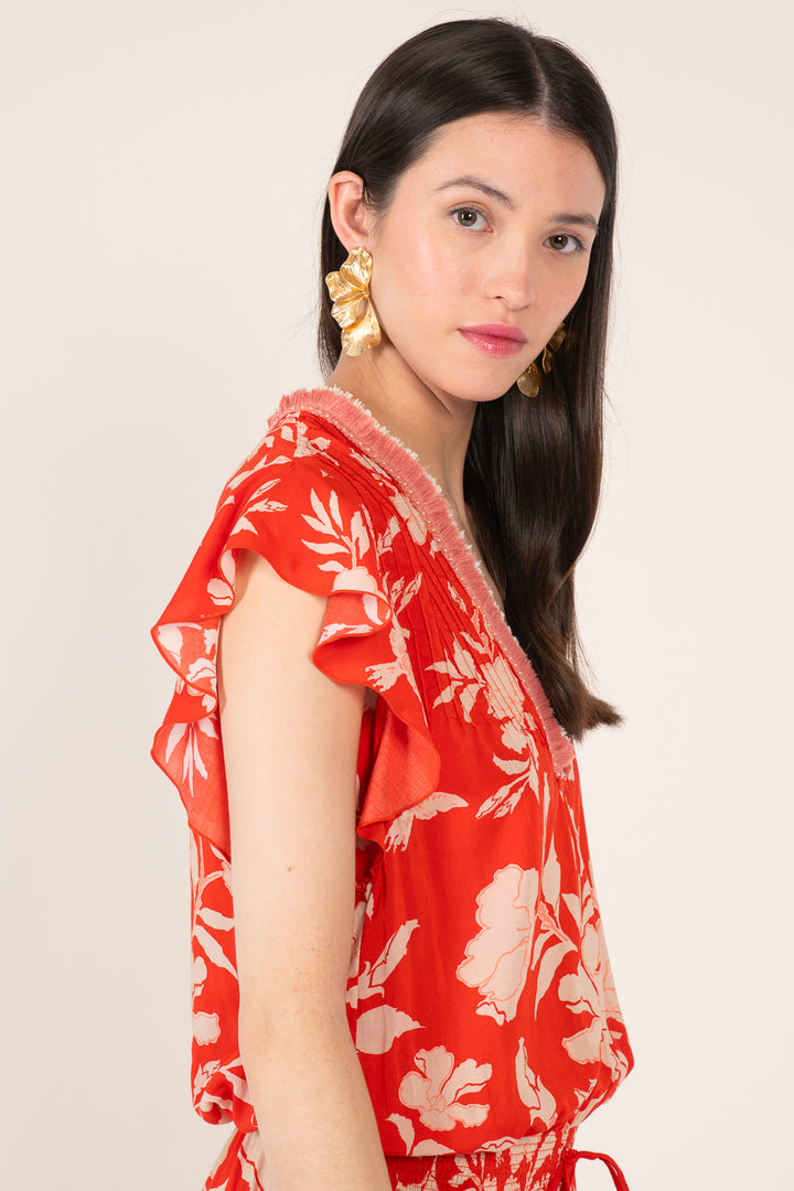 Poupette St Barth short jumpsuit in coral with palm beach print, featuring a relaxed fit and stylish summer design.