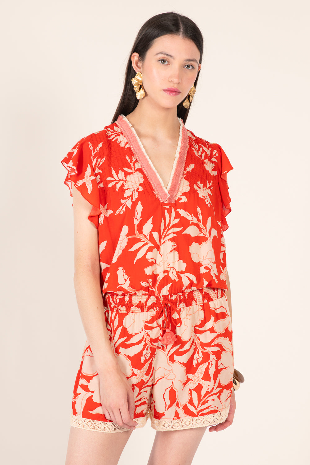 Coral palm print short jumpsuit by Poupette St Barth with a relaxed fit and adjustable straps, perfect for warm weather.