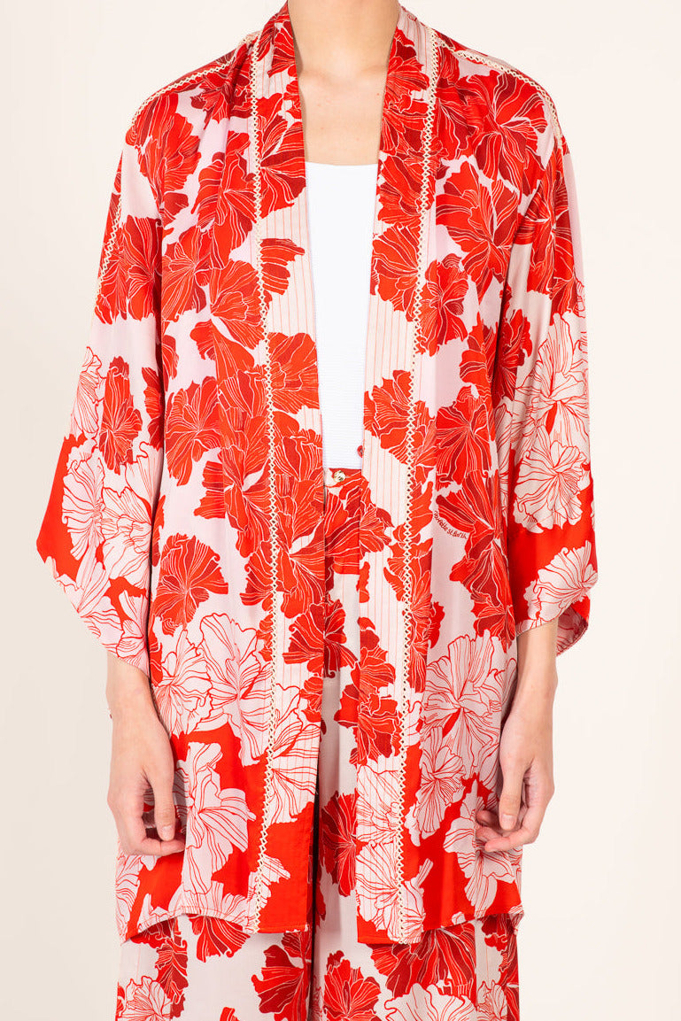 Red silk kimono cover-up with floral pattern from Poupette St Barth Luna collection featuring a vibrant flower bunch design.