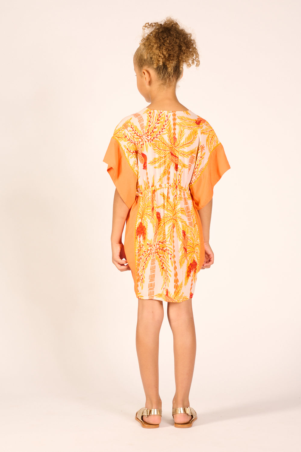 Yellow Poupette St Barth girl’s kaftan dress with mini palm print, long flowing style, perfect for warm weather and casual occasions.