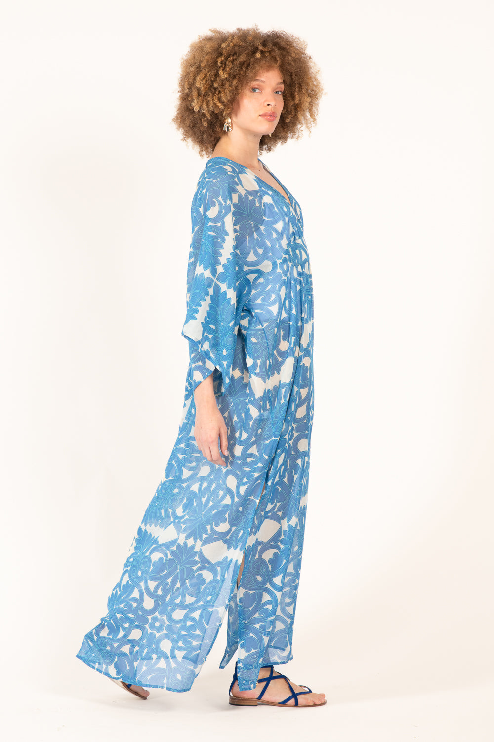 Long blue Kaftan Sol by Poupette St Barth featuring flowing fabric and intricate patterns, perfect for elegant summer wear.