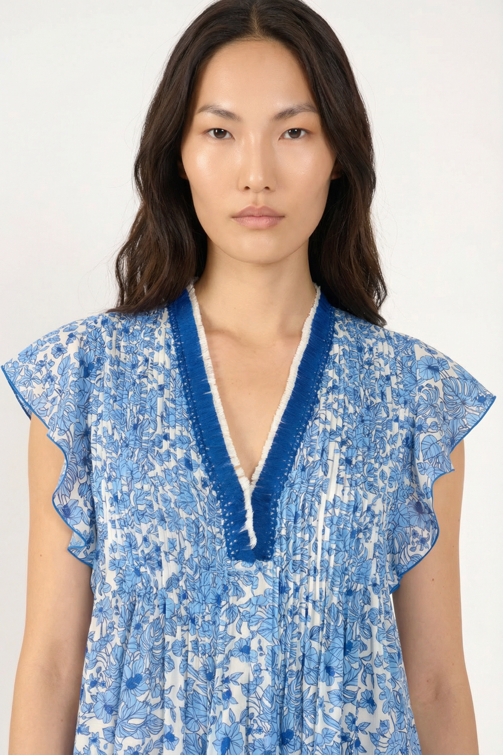 Close-up of the Poupette St Barth Mini Dress Sasha in vibrant blue Aquaflora, showcasing its fabric and stylish design.