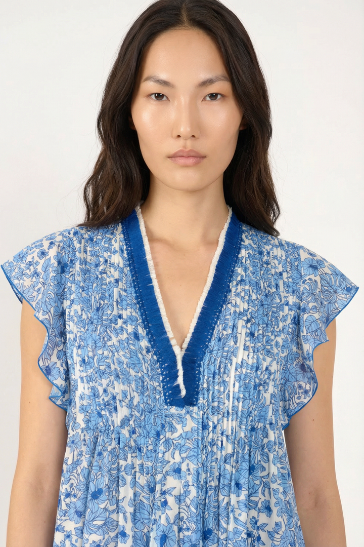 Close-up of the Poupette St Barth Mini Dress Sasha in vibrant blue Aquaflora, showcasing its fabric and stylish design.