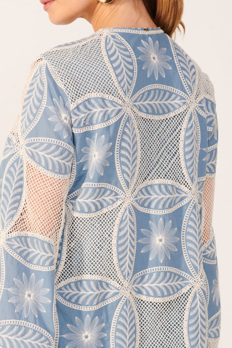 Blue Poupette St Barth Mini Dress Gia made of cotton eyelet fabric, featuring a feminine mandala pattern and a stylish mini length.