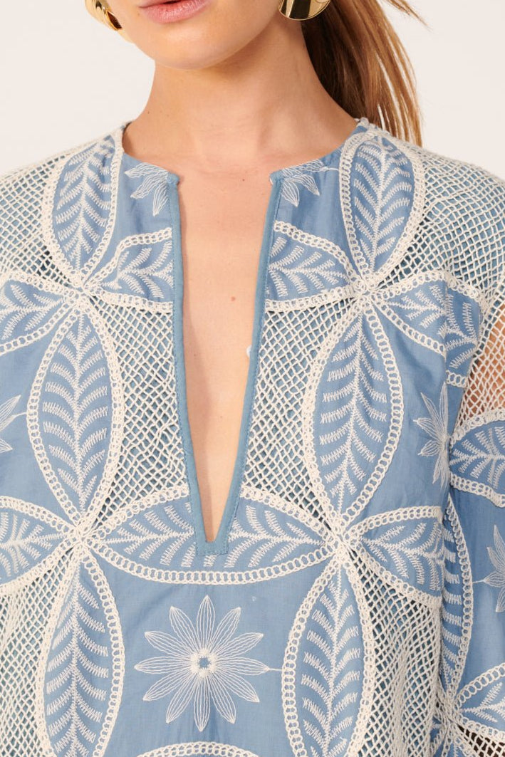 Blue Poupette St Barth Gia Mini Dress made of cotton eyelet with mandala pattern, short sleeves and a fitted silhouette.