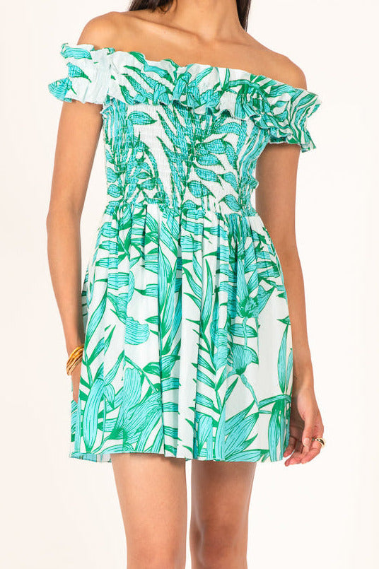 Poupette St Barth Amber Mini Dress in green palm leaf cotton fabric, sleeveless with a fitted silhouette and front tie detail.