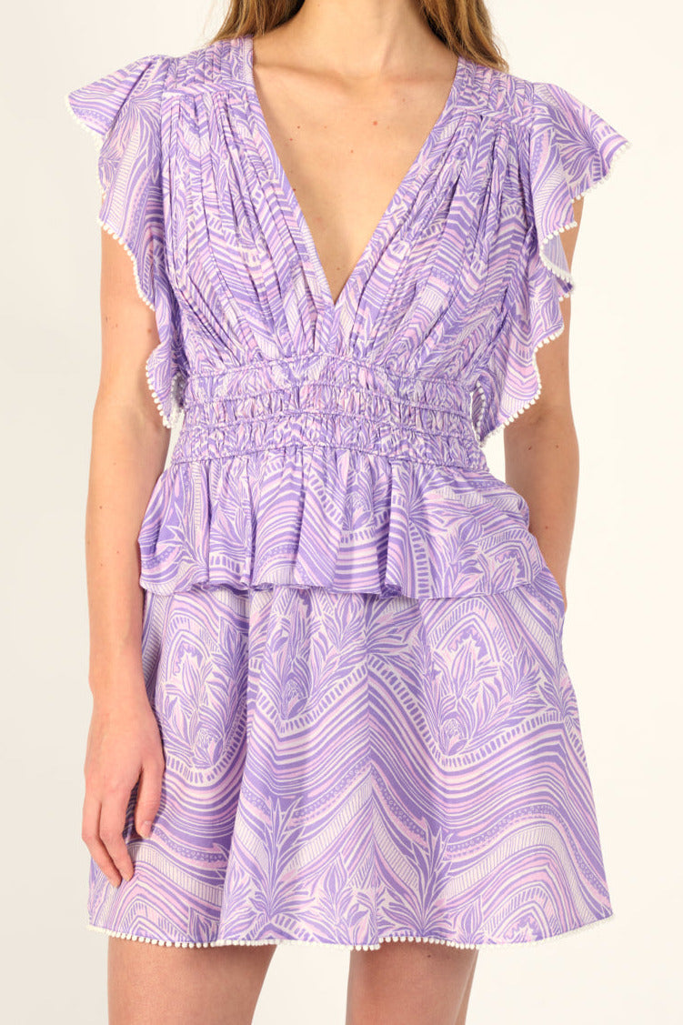 Lilac Mini Dress Noemi by Poupette St Barth, made of cotton, shown on a hanger with a flowy, casual style.