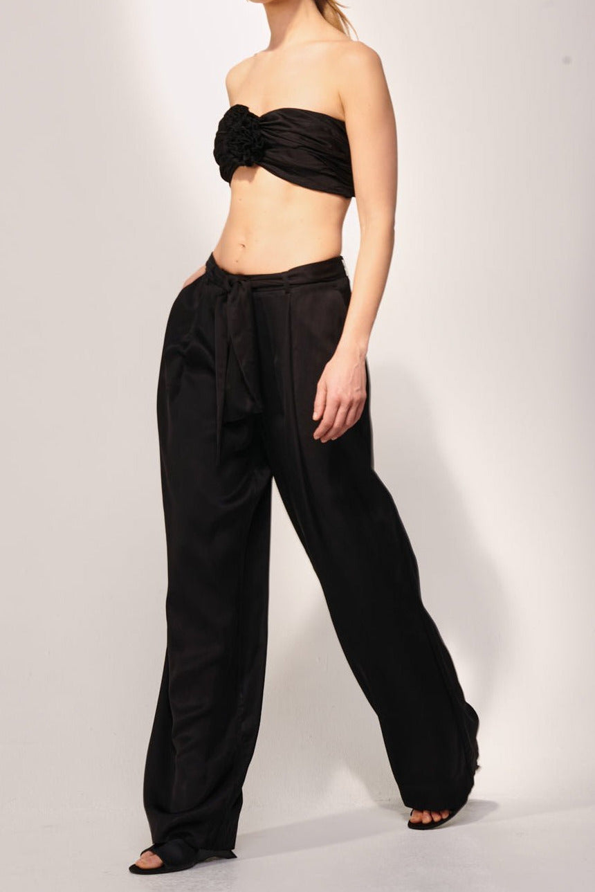 Black viscose satin Pant Aroa by Poupette St Barth, showing the lightweight, flowy fabric and relaxed fit of the pants.
