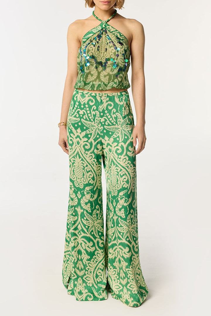 Green macro ikat pants by Poupette St Barth, featuring a relaxed fit and vibrant pattern perfect for casual summer wear.