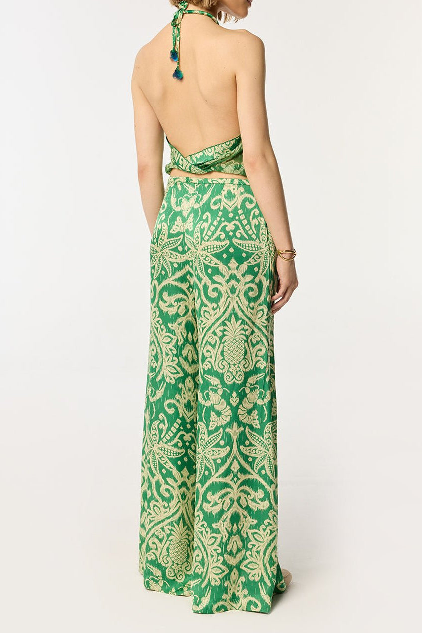Green macro ikat pants by Poupette St Barth featuring a relaxed fit and vibrant pattern, perfect for casual or beachwear.
