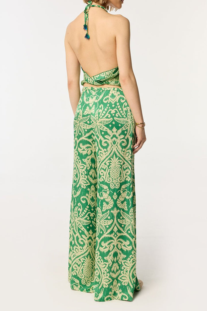 Green macro ikat pants by Poupette St Barth featuring a relaxed fit and vibrant pattern, perfect for casual or beachwear.