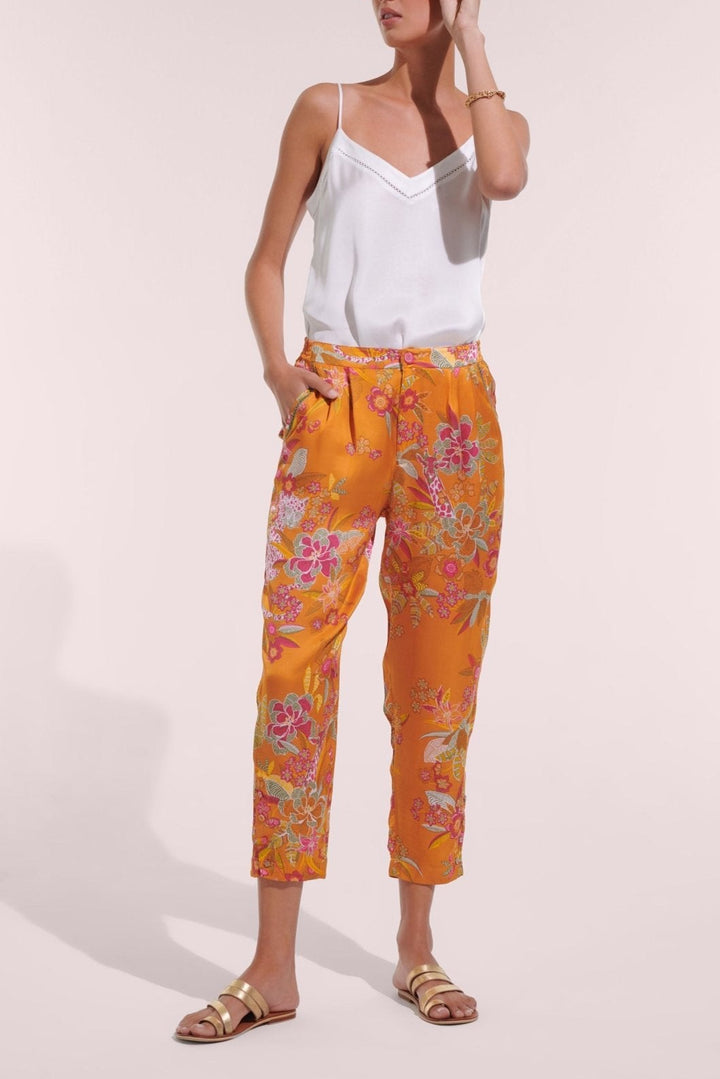 Poupette St Barth orange Leo Forest pants featuring a relaxed fit and vibrant animal print fabric.